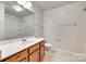 Bathroom with a large vanity, mirror and shower-tub combo at 5033 Mockernut Ln, Indian Land, SC 29707