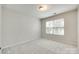 Bedroom with neutral carpet, light gray walls, and a window with wooded views at 5033 Mockernut Ln, Indian Land, SC 29707
