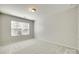 Well-lit bedroom with a large window and neutral carpeting at 5033 Mockernut Ln, Indian Land, SC 29707