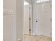 Bright entryway with wood-look flooring, a white front door and an open interior door at 5033 Mockernut Ln, Indian Land, SC 29707