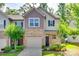 Charming townhome exterior with brick accents, attached garage, and manicured lawn at 5033 Mockernut Ln, Indian Land, SC 29707