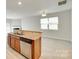 Open kitchen featuring granite countertops, stainless appliances and a view to the living area at 5033 Mockernut Ln, Indian Land, SC 29707
