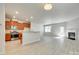 Open-concept living space with fireplace, light wood floors, and ample natural light at 5033 Mockernut Ln, Indian Land, SC 29707