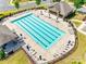 Aerial view of community pool and lounge area, featuring multiple chairs and umbrellas at 5033 Mockernut Ln, Indian Land, SC 29707
