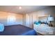 Serene bedroom boasts a comfortable bed, a dresser, and neutral color scheme at 5110 Hyrule Dr, Charlotte, NC 28262