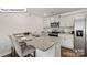Modern kitchen showcasing granite countertops, stainless steel appliances and breakfast bar seating at 5110 Hyrule Dr, Charlotte, NC 28262