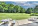 Expansive backyard with lush greenery and patio seating area, ideal for outdoor relaxation and entertaining at 604 Palmerston Ln, Waxhaw, NC 28173
