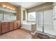 Bright bathroom with double vanity, separate tub, and glass-enclosed shower at 604 Palmerston Ln, Waxhaw, NC 28173