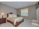 Comfortable bedroom with a large window and a decorative headboard at 604 Palmerston Ln, Waxhaw, NC 28173