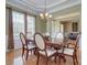 Formal dining room features hardwood floors, a decorative chandelier, and wainscoting at 604 Palmerston Ln, Waxhaw, NC 28173