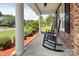 Inviting front porch with rocking chairs, perfect for relaxing and enjoying the neighborhood views at 604 Palmerston Ln, Waxhaw, NC 28173