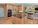 Well-appointed kitchen featuring a granite island, stainless steel appliances, and hardwood flooring for easy entertaining at 604 Palmerston Ln, Waxhaw, NC 28173