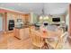 Inviting kitchen with wooden cabinets, granite countertops, a center island, and a cozy breakfast nook at 604 Palmerston Ln, Waxhaw, NC 28173