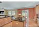 Open-concept kitchen showcasing a large island with seating, stainless steel appliances, and hardwood floors at 604 Palmerston Ln, Waxhaw, NC 28173