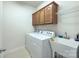 Functional laundry room with washer, dryer, and utility sink at 604 Palmerston Ln, Waxhaw, NC 28173