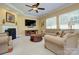 Comfortable living room featuring a fireplace, neutral decor, and ample seating, creating a warm and inviting atmosphere at 604 Palmerston Ln, Waxhaw, NC 28173