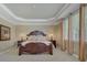 Comfortable bedroom with a tray ceiling, side tables and lamps at 604 Palmerston Ln, Waxhaw, NC 28173