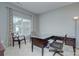 Well-lit home office with a large desk and two decorative chairs at 604 Palmerston Ln, Waxhaw, NC 28173