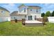 Backyard featuring a deck, green grass and mature trees at 7442 Sparkleberry Dr, Indian Trail, NC 28079