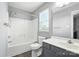 Bathroom with shower over tub, gray vanity and natural light at 7442 Sparkleberry Dr, Indian Trail, NC 28079