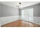 Bright bedroom featuring modern lighting, hardwood floors, and elegant wall detailing at 7442 Sparkleberry Dr, Indian Trail, NC 28079