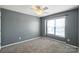 Carpeted bedroom with neutral walls, a ceiling fan, and natural light at 7442 Sparkleberry Dr, Indian Trail, NC 28079