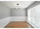 Dining room showcasing modern lighting, hardwood floors, and elegant wall detailing at 7442 Sparkleberry Dr, Indian Trail, NC 28079