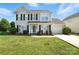 Charming two-story home featuring black shutters, a manicured lawn, and a single-car garage at 7442 Sparkleberry Dr, Indian Trail, NC 28079