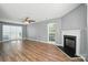 Spacious living room showcasing hardwood floors, a fireplace, and large windows at 7442 Sparkleberry Dr, Indian Trail, NC 28079