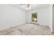 This bedroom features a ceiling fan and window with exterior view, but needs new carpeting at 7501 Glencannon Dr, Charlotte, NC 28227