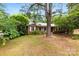 Charming single-story brick home with mature trees and a cozy front porch at 7501 Glencannon Dr, Charlotte, NC 28227