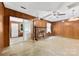 Cozy living room with brick fireplace and wood paneling for a rustic feel at 7501 Glencannon Dr, Charlotte, NC 28227