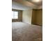 Large carpeted bedroom with a bright window, neutral walls, and ample space at 8125 Weeping Fig Ln, Charlotte, NC 28215