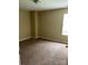 Bedroom with neutral carpet and wall paint with natural light from the window, for a simple and cozy space at 8125 Weeping Fig Ln, Charlotte, NC 28215