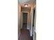 Upstairs hallway with carpet flooring, white trim, and neutral wall paint at 8125 Weeping Fig Ln, Charlotte, NC 28215