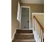 Staircase leading up to a storage space, featuring carpeted steps and a white railing at 8125 Weeping Fig Ln, Charlotte, NC 28215