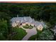 Breathtaking aerial view of an elegant estate home with lush greenery and a circular driveway. Perfect for luxurious living at 8500 Longview Club Dr, Waxhaw, NC 28173