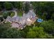 Expansive estate home with swimming pool, stone accents, and lush landscaping, perfect for luxurious living and entertaining at 8500 Longview Club Dr, Waxhaw, NC 28173