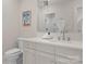 Bright bathroom with white cabinets, vanity, silver fixtures, and framed artwork at 8500 Longview Club Dr, Waxhaw, NC 28173