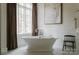 Spa-like bathroom features a soaking tub, marble tile, and elegant fixtures at 8500 Longview Club Dr, Waxhaw, NC 28173