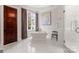 Elegant bathroom boasts marble floors, soaking tub, and a separate glass-enclosed shower at 8500 Longview Club Dr, Waxhaw, NC 28173