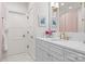 Bathroom with bright white vanity, marble floors, and gold fixtures at 8500 Longview Club Dr, Waxhaw, NC 28173