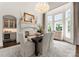 Bright dining room showcases a fireplace, chandelier, and bay windows overlooking the yard at 8500 Longview Club Dr, Waxhaw, NC 28173
