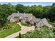Expansive estate home with beautiful landscaping, stone accents, and a circular driveway, perfect for luxurious living at 8500 Longview Club Dr, Waxhaw, NC 28173