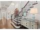 Grand foyer featuring an elegant staircase, dark wood floors, and a view into the living room at 8500 Longview Club Dr, Waxhaw, NC 28173