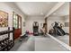 Home gym featuring exercise equipment, weights, and mirrored wall at 8500 Longview Club Dr, Waxhaw, NC 28173