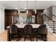 Kitchen boasts a marble island, wine fridges, dark cabinets and bar stool seating at 8500 Longview Club Dr, Waxhaw, NC 28173