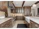 Stylish kitchen boasts stainless steel appliances, marble counters, and custom wood cabinets at 8500 Longview Club Dr, Waxhaw, NC 28173