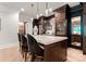 Kitchen boasts a marble island, wine fridges, dark cabinets and bar stool seating at 8500 Longview Club Dr, Waxhaw, NC 28173