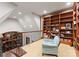 Upstairs landing with built-in shelving, sitting area, and wrought iron railing at 8500 Longview Club Dr, Waxhaw, NC 28173